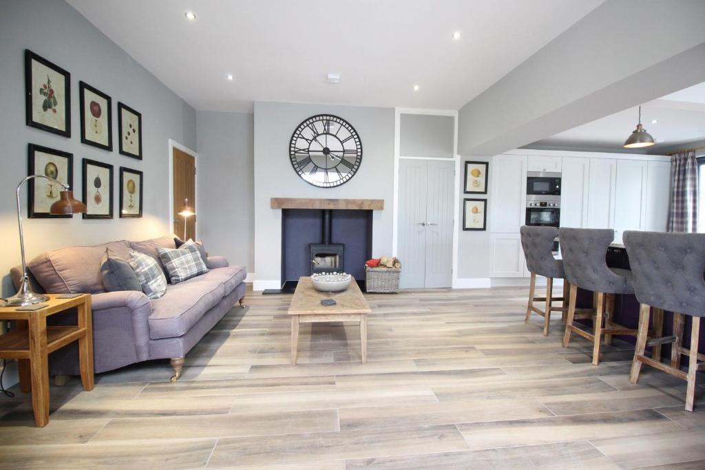 a living room with a couch and a table at Lake View luxury home with Lake Ullswater view & 2 ground floor bedrooms ideal for 2 families in Watermillock