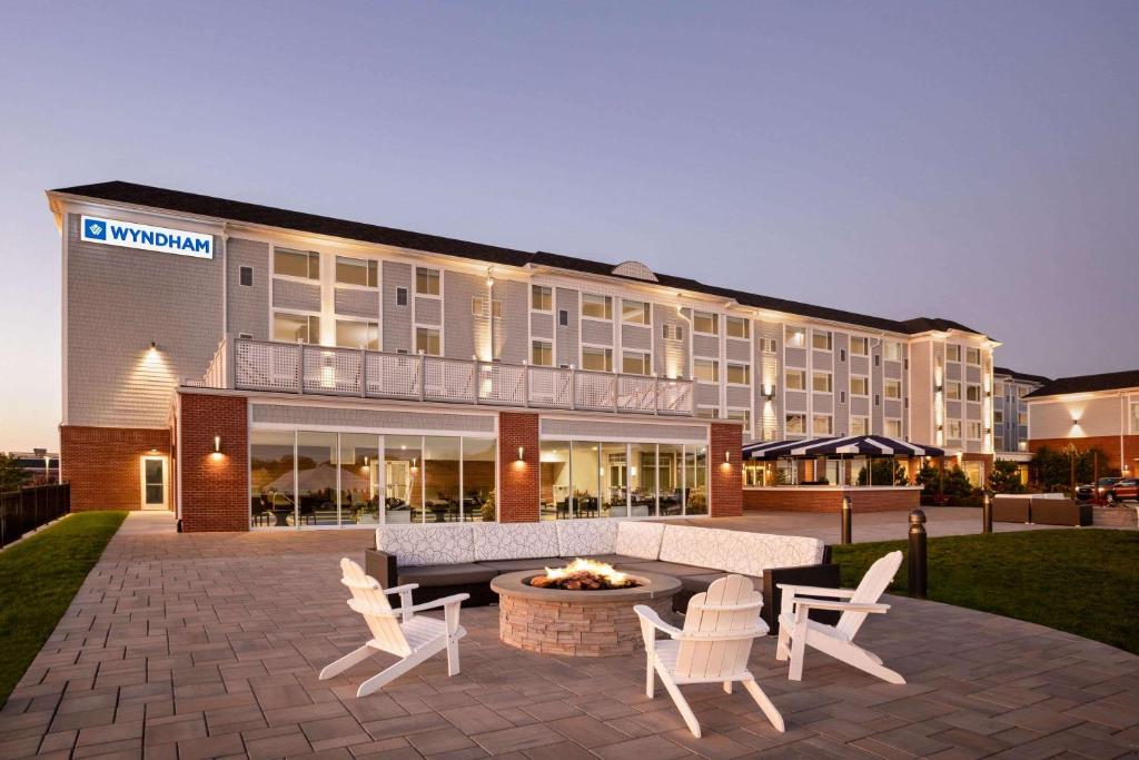 a hotel with a fire pit in front of a building at Wyndham Newport Hotel in Middletown