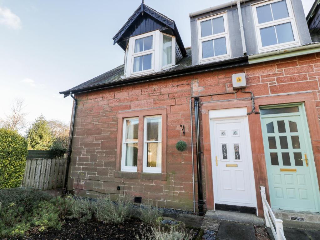 a red brick house with a white door at 1 Alpine Place in Thornhill