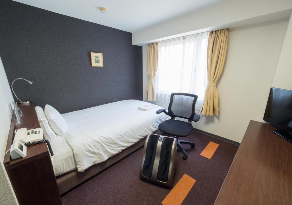 Postel nebo postele na pokoji v ubytování Hotel Shin Osaka