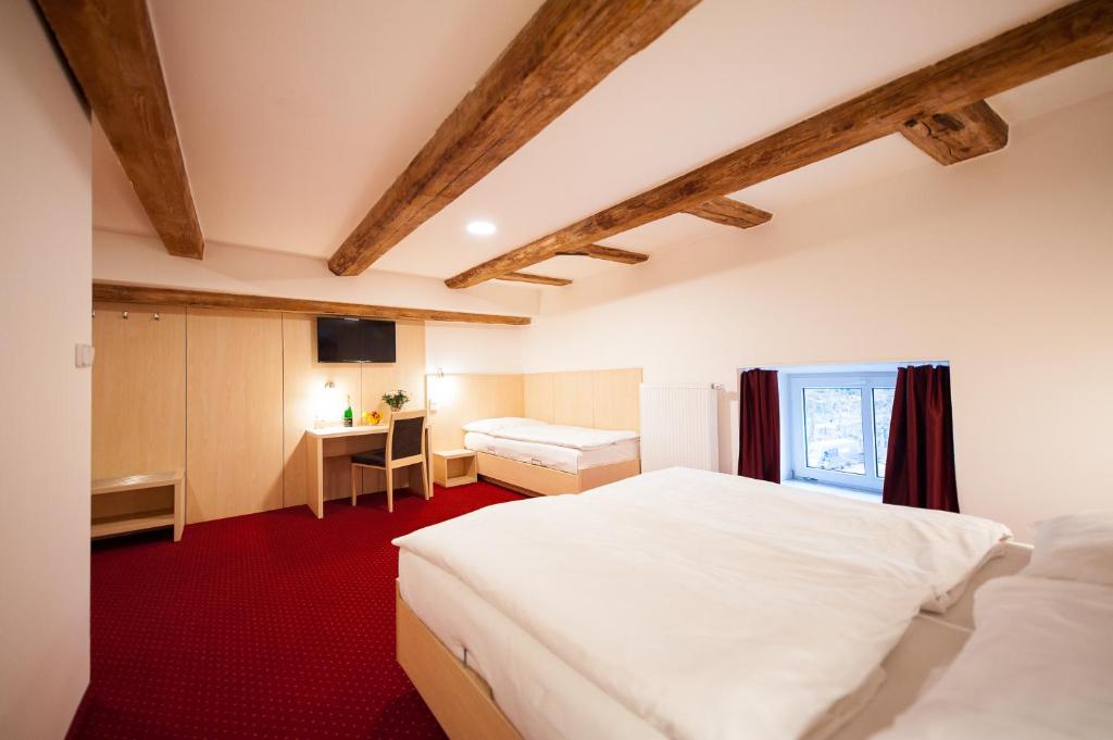 Postel nebo postele na pokoji v ubytování Hotel Pivovar