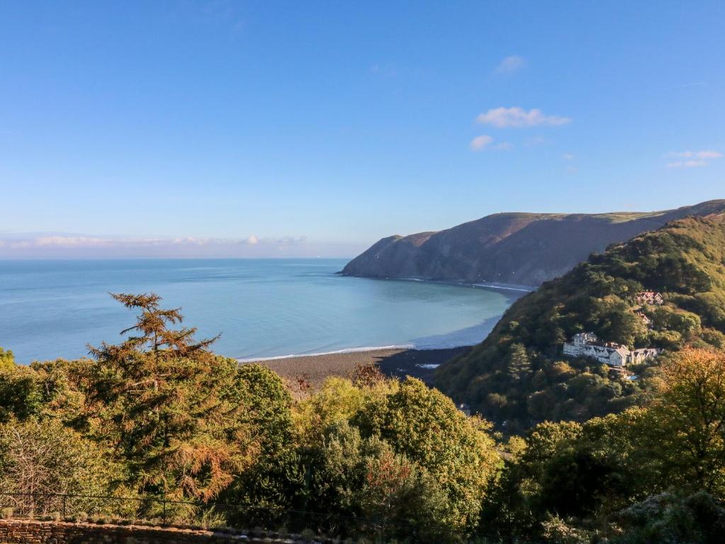 a view of a beach with trees and the ocean at Blue Bay in Lynton