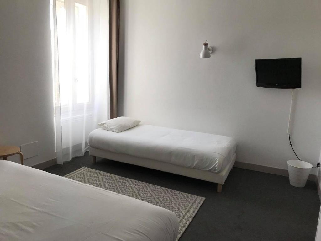 Postel nebo postele na pokoji v ubytování L'Annexe Plaisance - Hôtel Non Climatisé