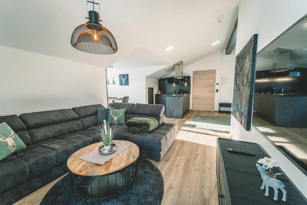 a living room with a couch and a table at Mirador Apartments in Seefeld in Tirol