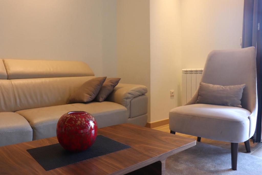 a living room with a couch and a chair at Hotel Villa Gracia in Budva