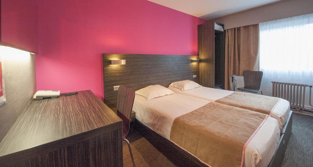 Postel nebo postele na pokoji v ubytování Ostend Hotel