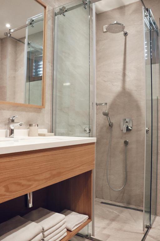a bathroom with a shower with a sink and a glass shower stall at Hotel Villa Gracia in Budva