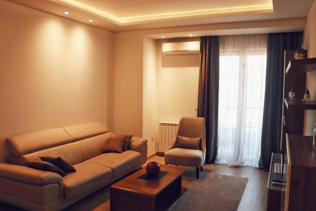 a living room with a couch and a chair at Hotel Villa Gracia in Budva
