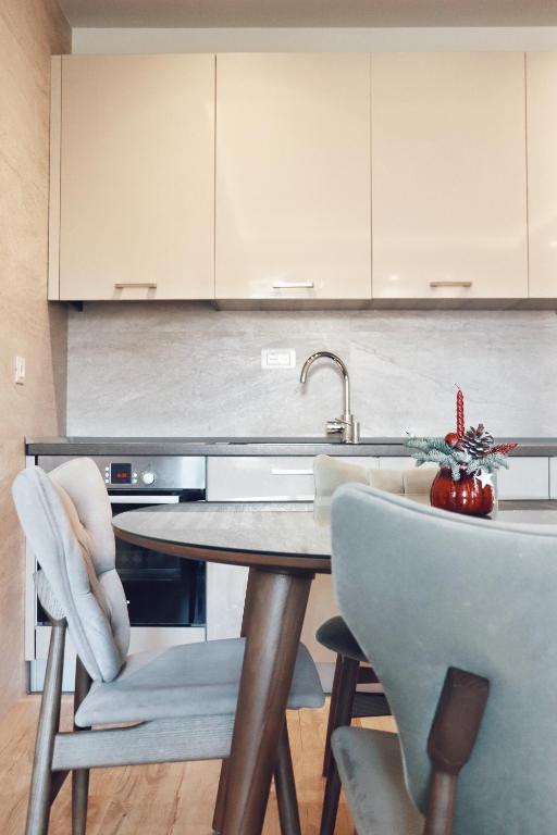a kitchen with a table and chairs and a sink at Hotel Villa Gracia in Budva