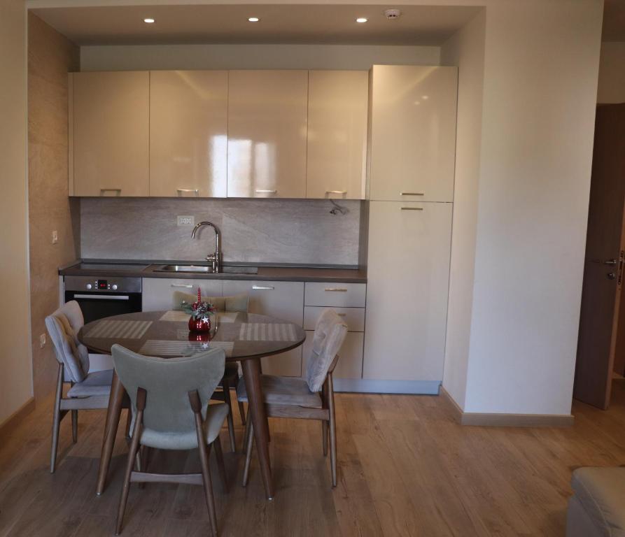 a kitchen with a table and chairs in a room at Hotel Villa Gracia in Budva