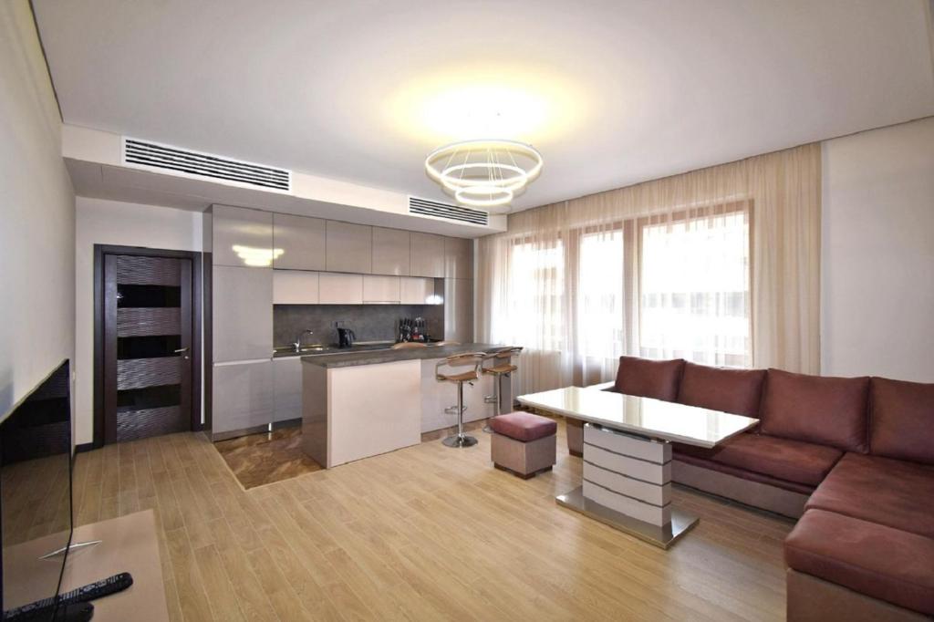 a living room with a couch and a table at Northern Avenue 2 bedrooms New and Modern apartment in New Elite Building HH600 in Yerevan