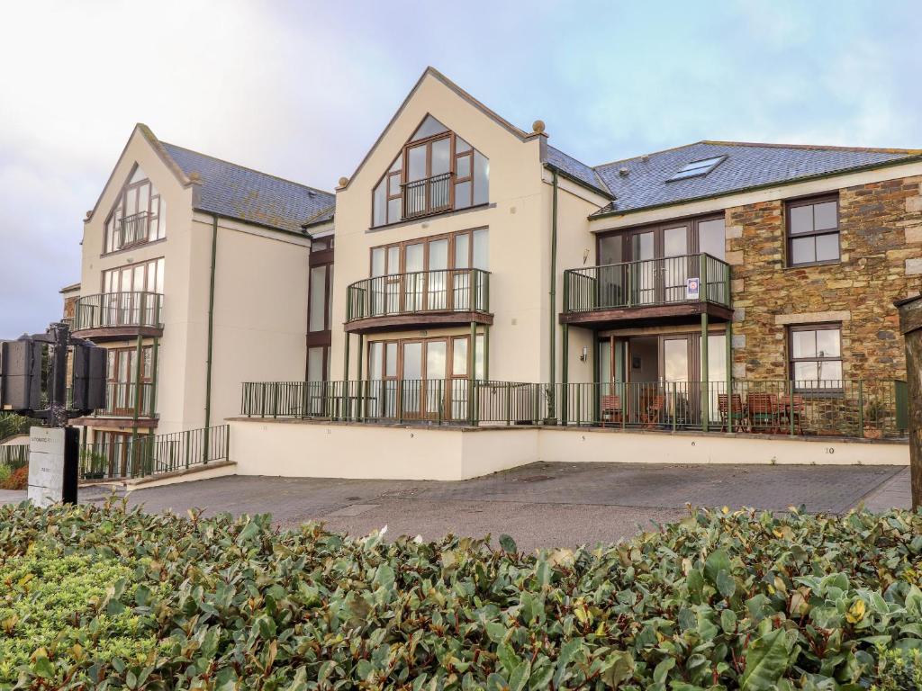 an apartment building with a hedge in front of it at Ocean Blue in Penzance