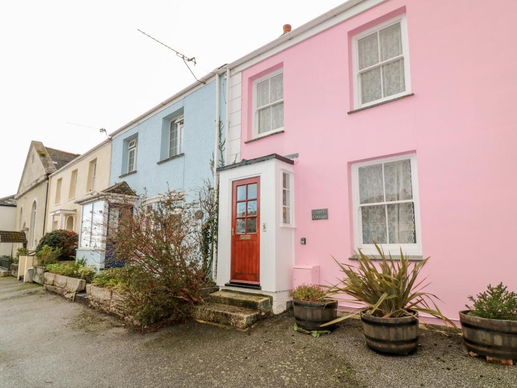 a row of colourful houses on a street at Tops'l Cottage in Falmouth