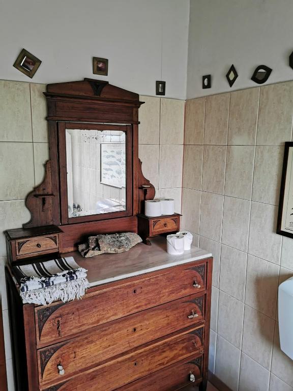 a wooden dresser with a cat sleeping on top of it at Hostel Argonauta in Óbidos