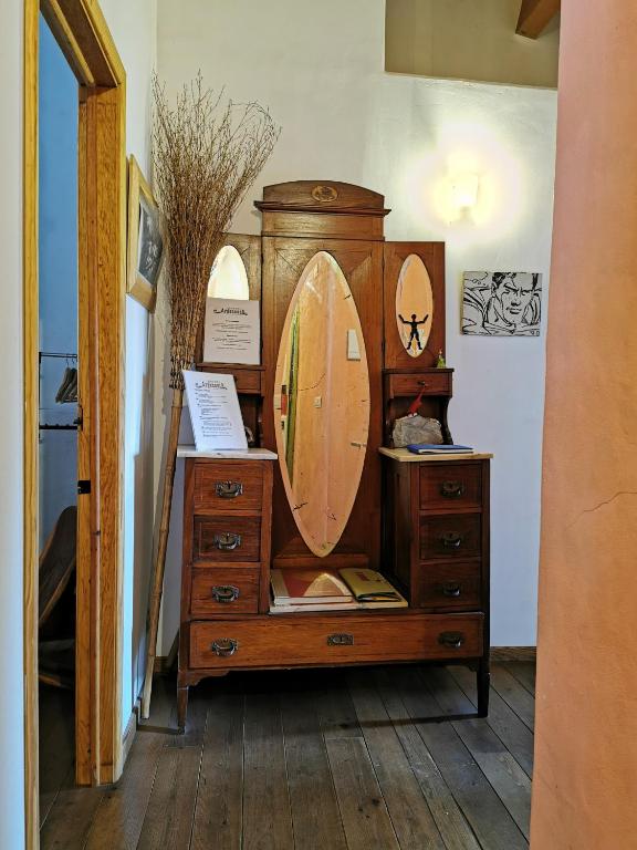 a wooden dresser with a surfboard on top of it at Hostel Argonauta in Óbidos