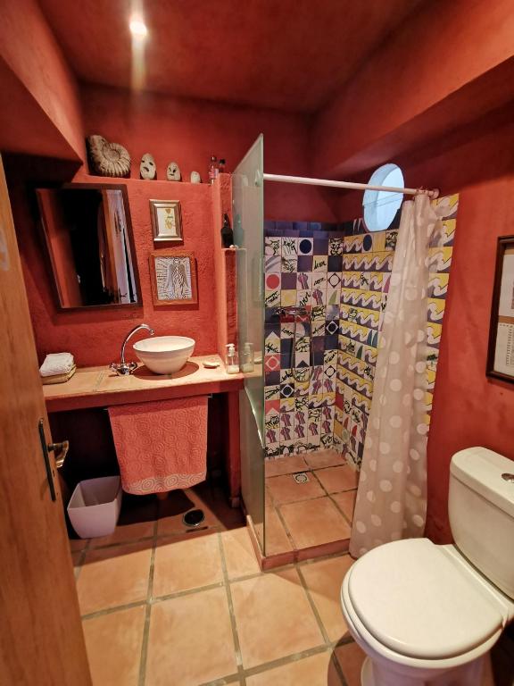 a bathroom with a shower and a toilet and a sink at Hostel Argonauta in Óbidos