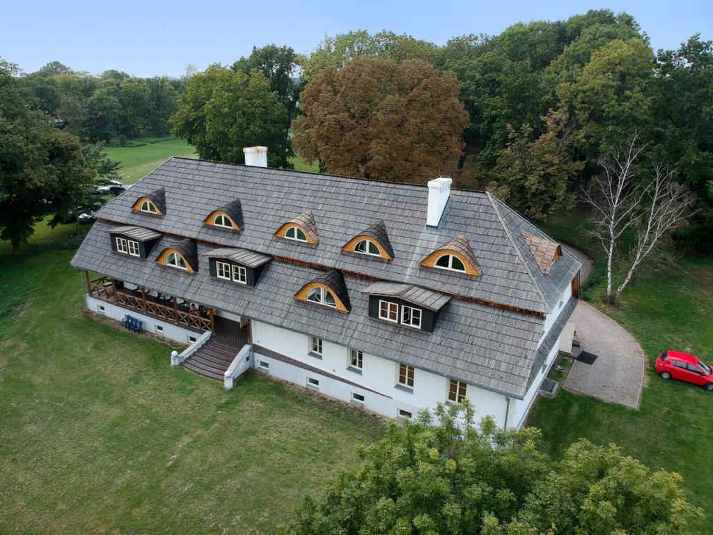 an aerial view of a house with a roof at Dwór Strzyżew in Żelazowa Wola