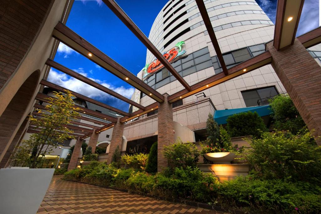 a building with a glass roof with a building at Hotel Alps in Osaka
