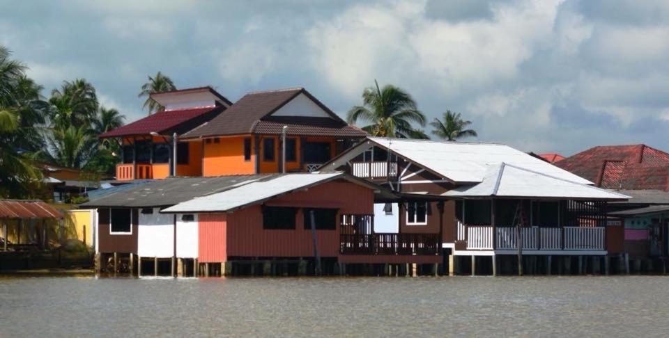 a group of houses on a flooded street at Maena Water Chalets in Tumpat