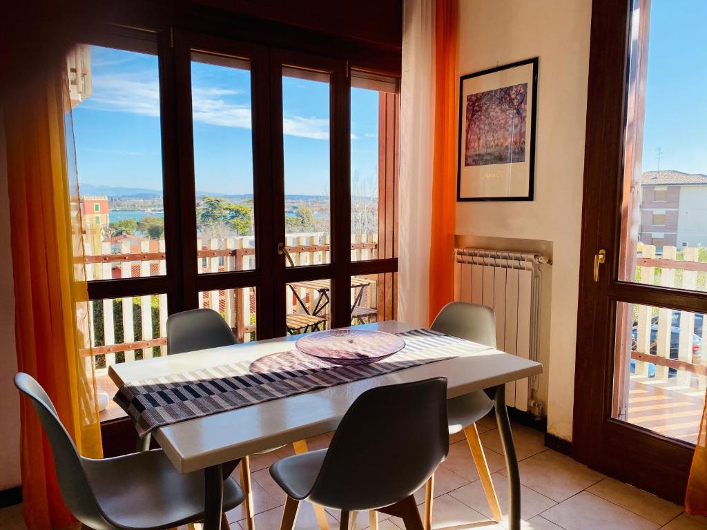 a keyboard sitting on a table in a room with a balcony at Residenza Cappuccini in Peschiera del Garda