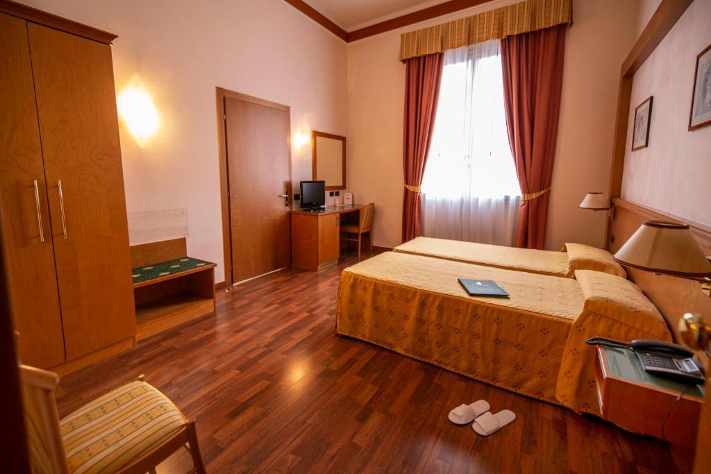 Postel nebo postele na pokoji v ubytování Hotel Estense