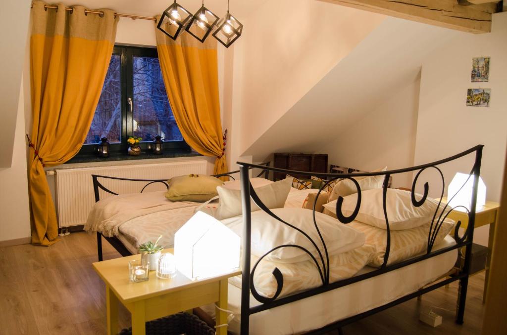 a bedroom with a bed and a table and a window at BY's home in Zagreb