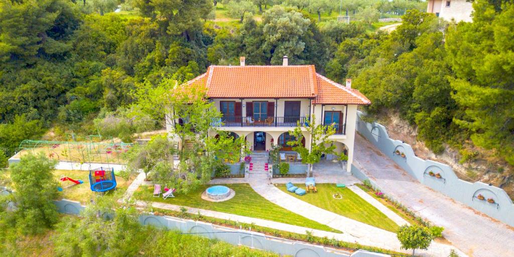 an aerial view of a house with a playground at Willow Sea View Villa, Kriopigi in Kriopigi