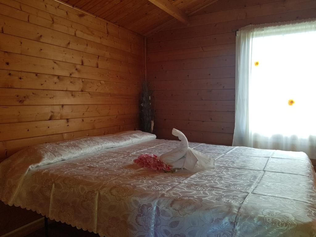 a bedroom with a bed with a white comforter at OASI PARK GARDEN CLUB in Fiumefreddo di Sicilia