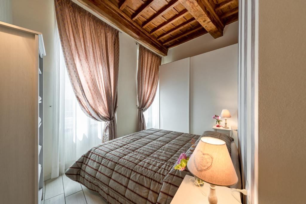 a bedroom with a bed with a lamp and a window at Windows On Florence in Florence