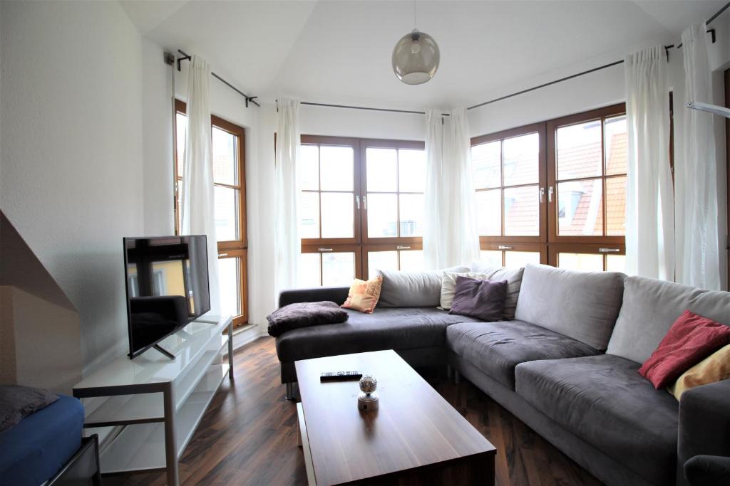 a living room with a couch and a tv at Zimmer in Innenstadtwohnung in Würzburg