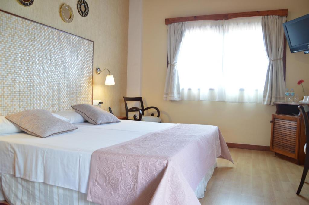 Postel nebo postele na pokoji v ubytování Gara Hotel
