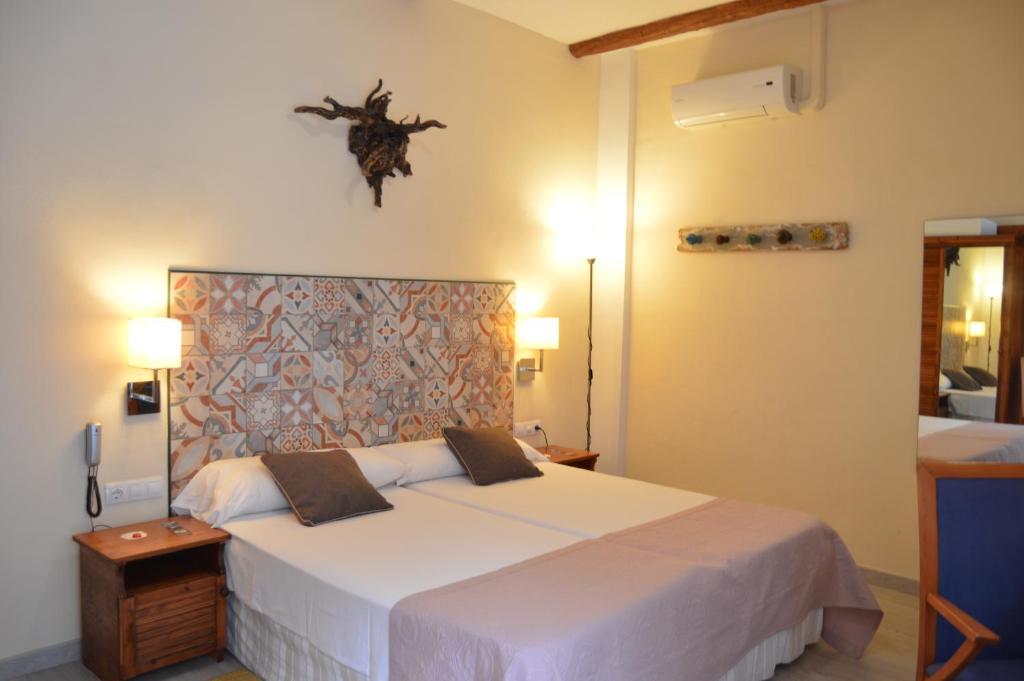 Postel nebo postele na pokoji v ubytování Gara Hotel