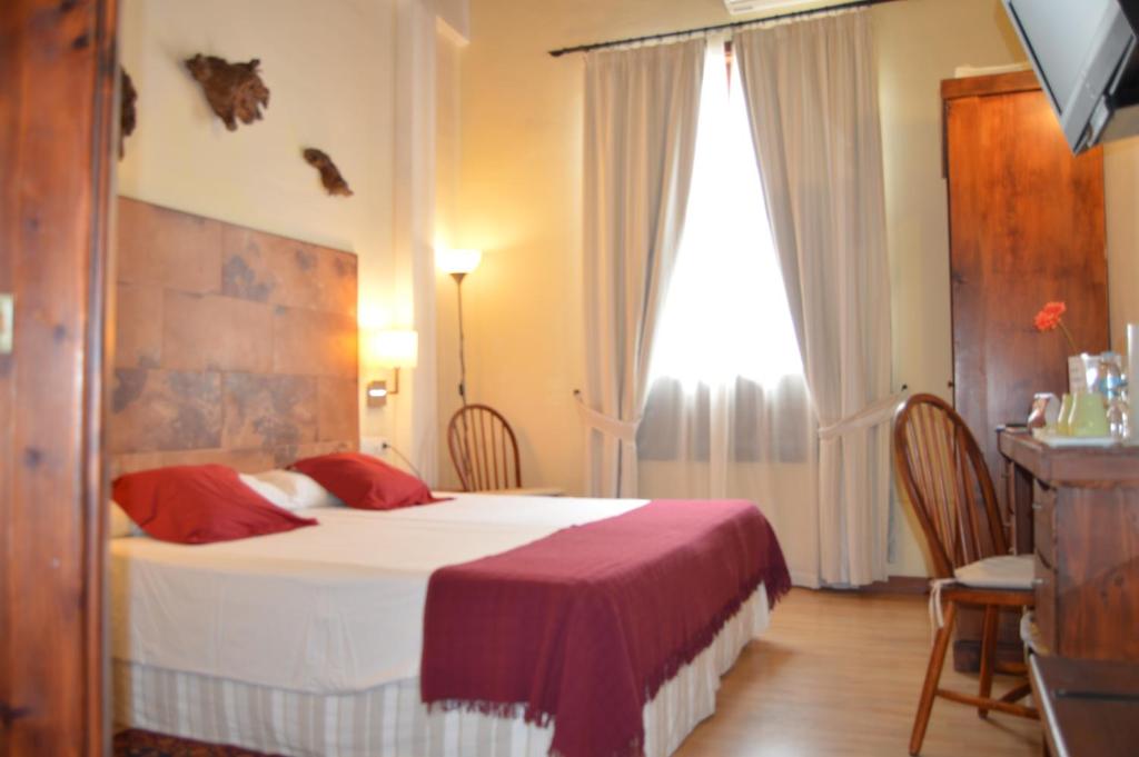 Postel nebo postele na pokoji v ubytování Gara Hotel