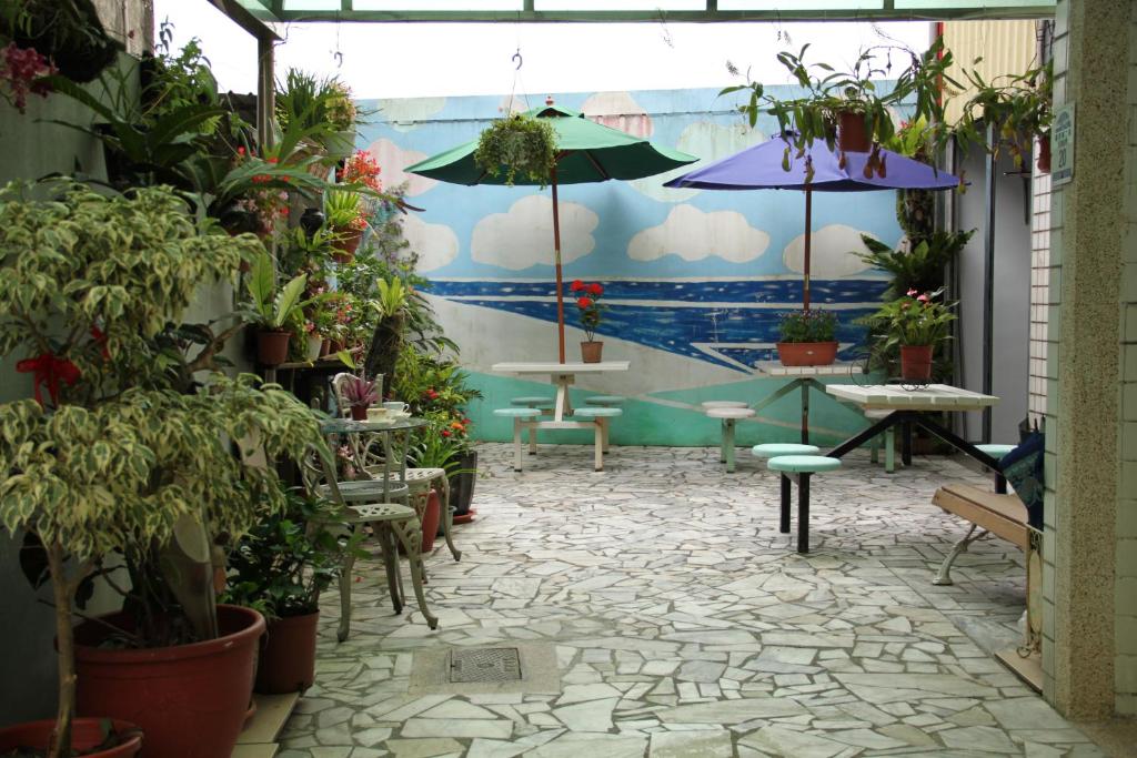 a patio with potted plants and tables and umbrellas at Winter&#39;s Love in Wujie