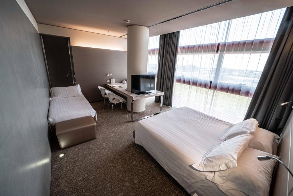 Krevet ili kreveti u jedinici u okviru objekta Best Western Plus Net Tower Hotel Padova