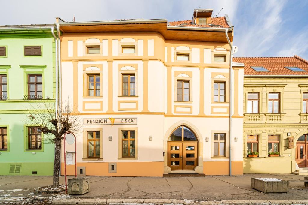 a large building in the middle of a street at Penzion Kiska Levoča in Levoča