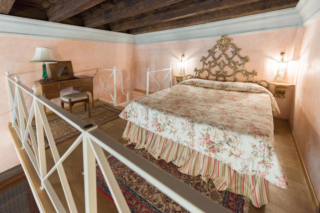 a bedroom with a large bed and a chair at Corte Dei Neri in Florence
