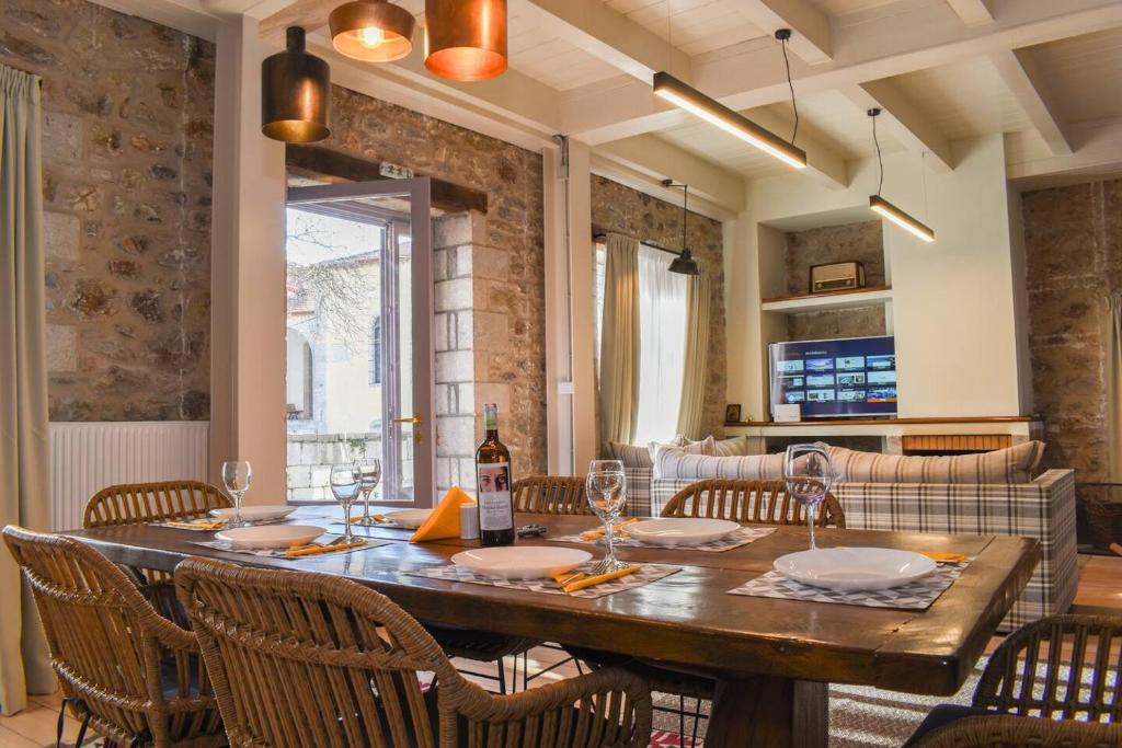 a dining room with a wooden table and chairs at Secluded Mountain Refuge - Theonimfi Paradise Gem in Dimitsana