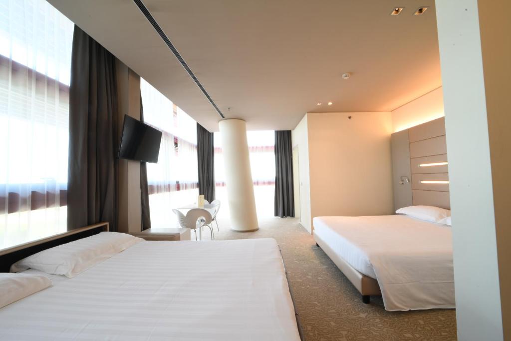 Krevet ili kreveti u jedinici u okviru objekta Best Western Plus Net Tower Hotel Padova