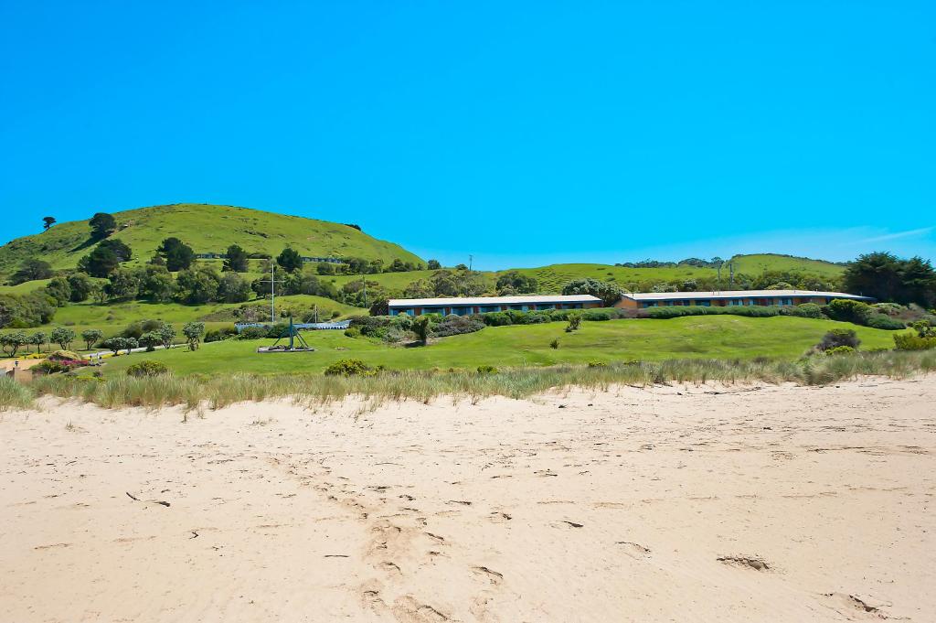 a train on a track next to a beach at Seafarers Getaway in Apollo Bay