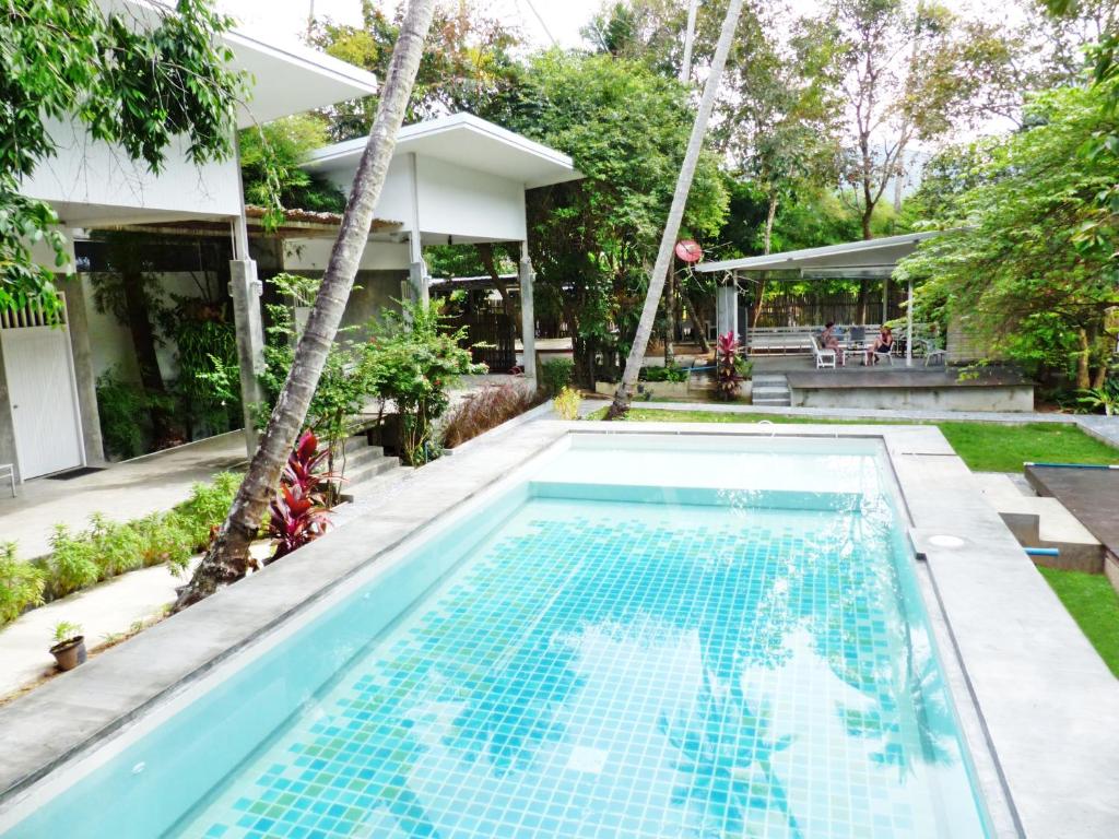 una piscina en el patio trasero de una casa en Glur Hostel, en Ao Nang Beach