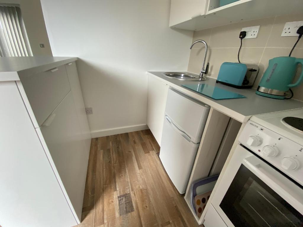 a small kitchen with a sink and a stove at Margate Seaside Retreat in Margate