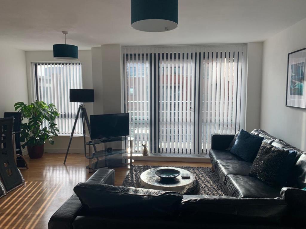 a living room with a couch and a table at Duke Street - Liverpool city centre apartment in Liverpool