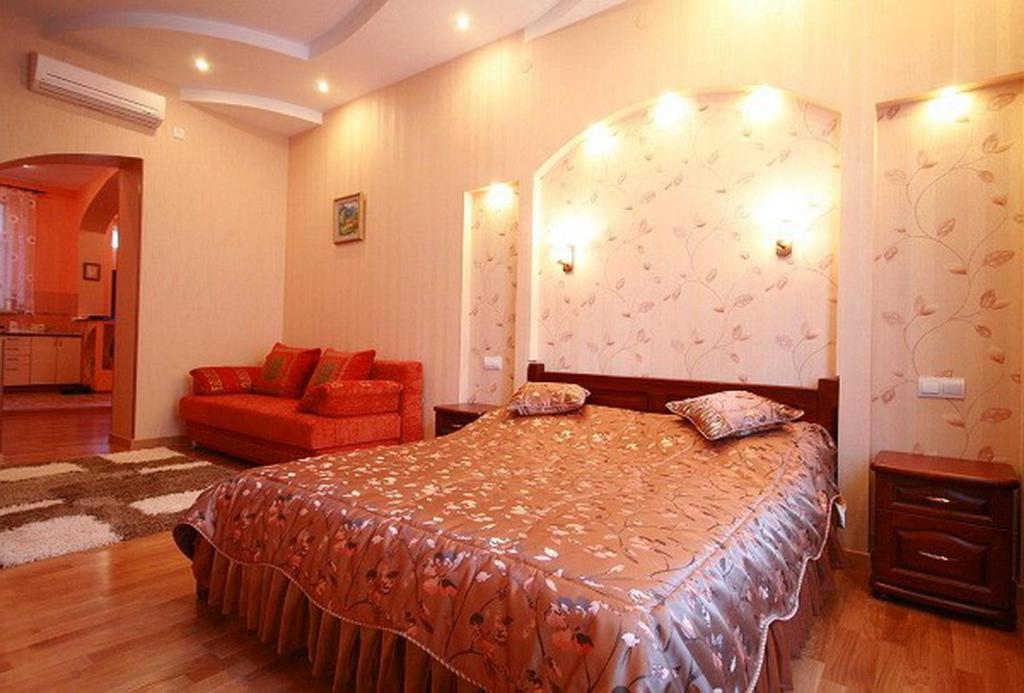 a bedroom with a bed and a dresser at Park and Opera Apartments in Lviv