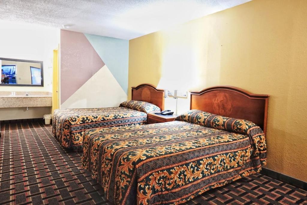 a hotel room with two beds in a room at Best Inn in Augusta