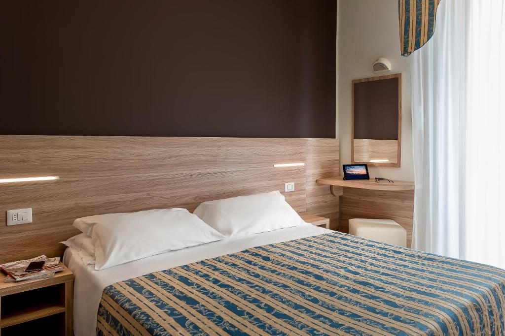 Postel nebo postele na pokoji v ubytování Hotel Sole Mio