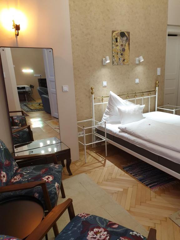 a bedroom with a bed and a large mirror at Madana apartman in Budapest