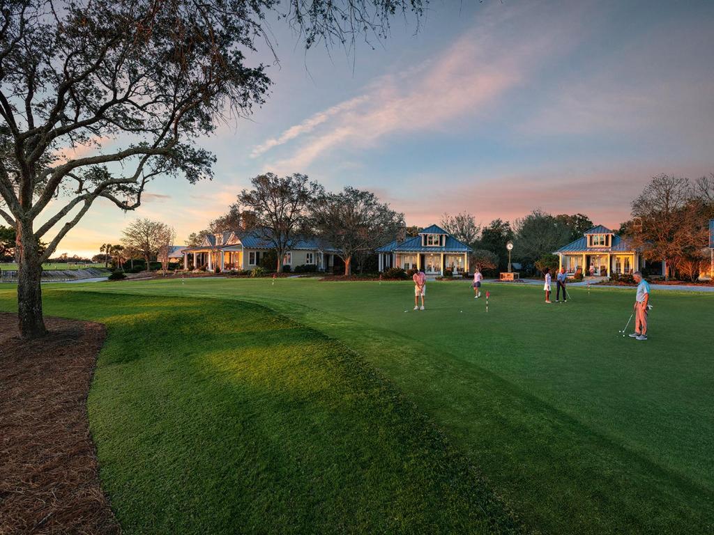 a group of people playing cricket on a golf course at The Lodge at Sea Island in Saint Simons Island