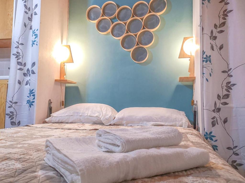 a bedroom with two beds with towels on them at Sweet Room in Campofelice di Roccella