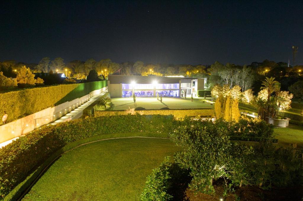 a view of a house at night with a garden at Miramare Gardens Boutique Accommodation in Terrey Hills